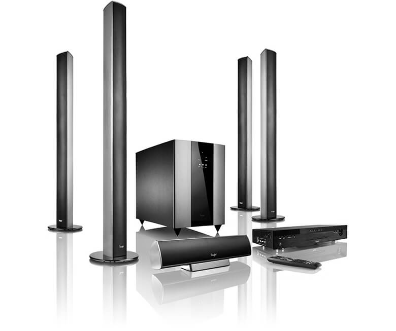 Home audio system featuring four tall speakers, a subwoofer, and a media player with remote control.